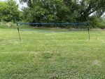 Badminton Net on the grass with shuttlecock & rackets included